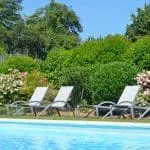 Photographie d'un jardin fleuri avec une piscine